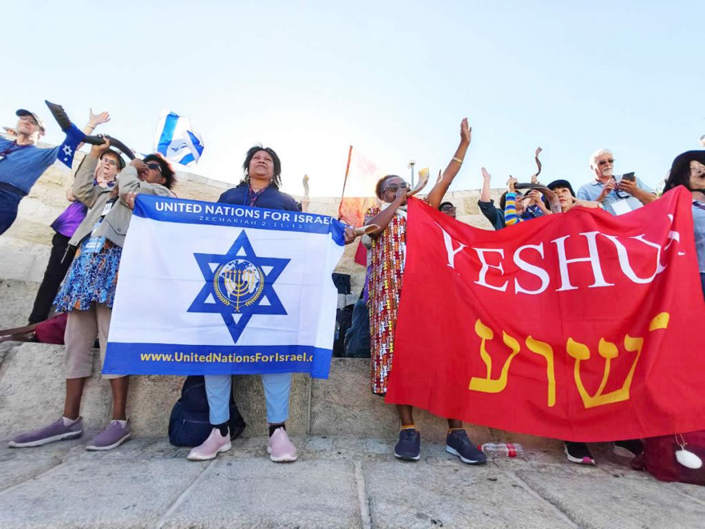 Group of people with UNIFY and Yeshua flags